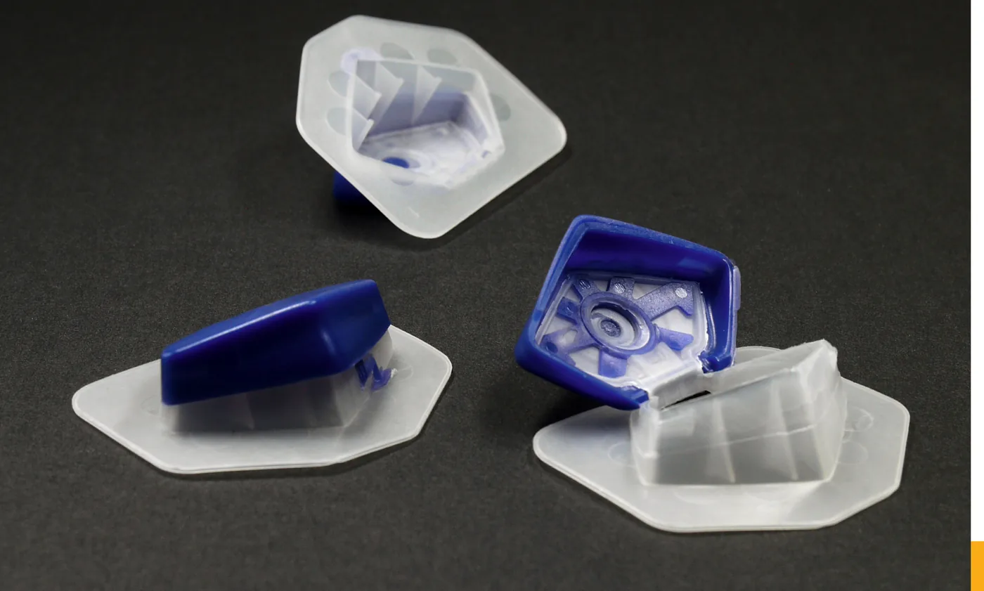 Two-component moulded Tetra Pak spouts, and one sealed onto a carton