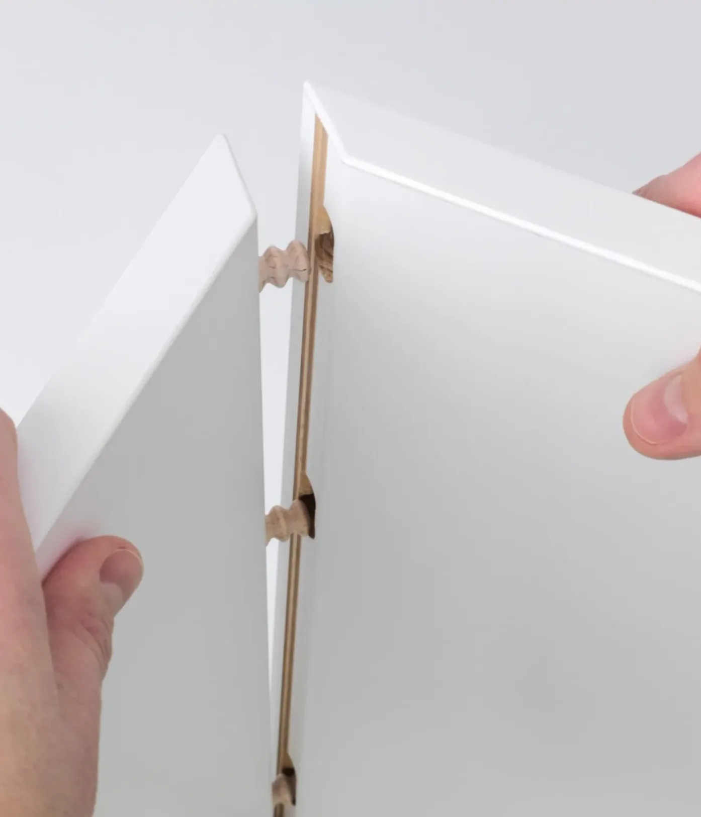 A wooden dowel welded into a furniture panel