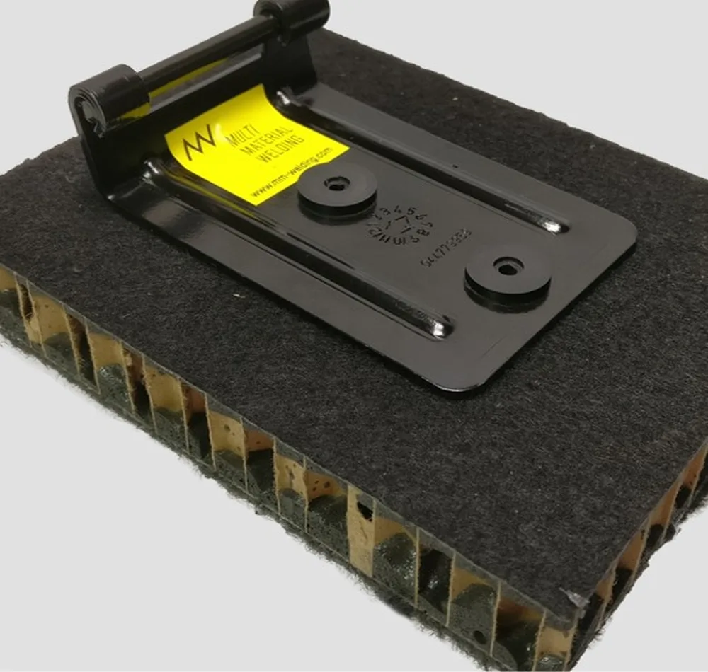 A steel bracket welded onto a honeycomb sandwich panel - fastened without a drilled hole